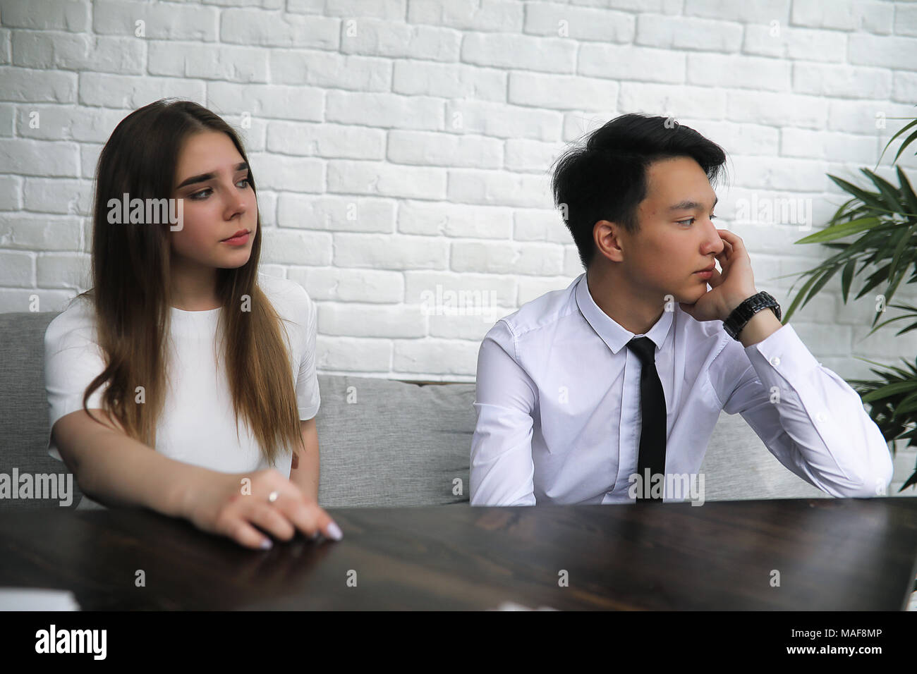 A pair of young people talking at the office table Stock Photo - Alamy