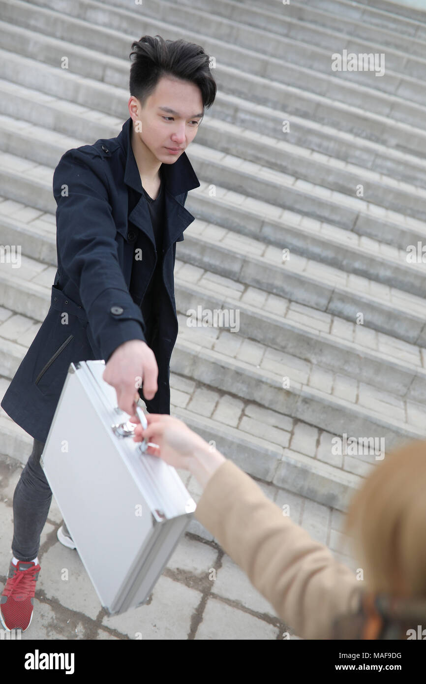 Asian Man With A Metal Suitcase In The City Asian And Silver Case