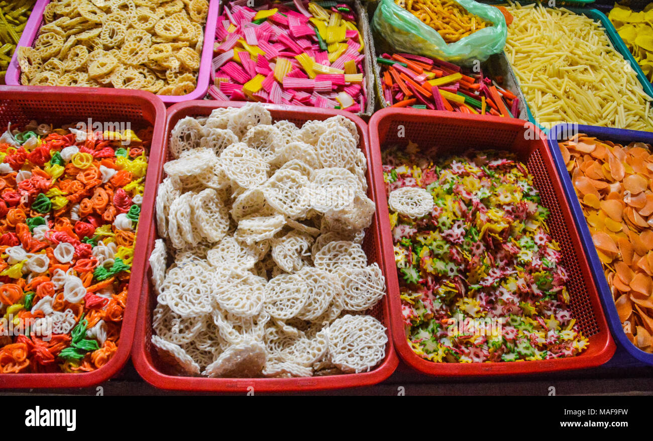 Assortment of colorful sweet Indonesian snacks at a local market stall in Medan City Stock Photo