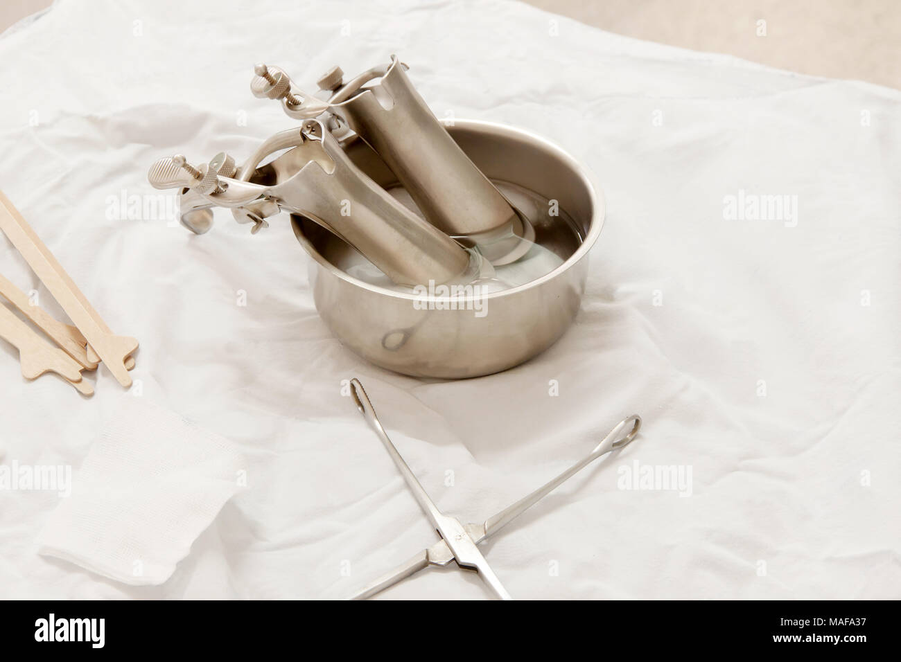 Vaginal Speculum sterilized in alcohol on Medical instruments table. Cervical Screening. Stock Photo