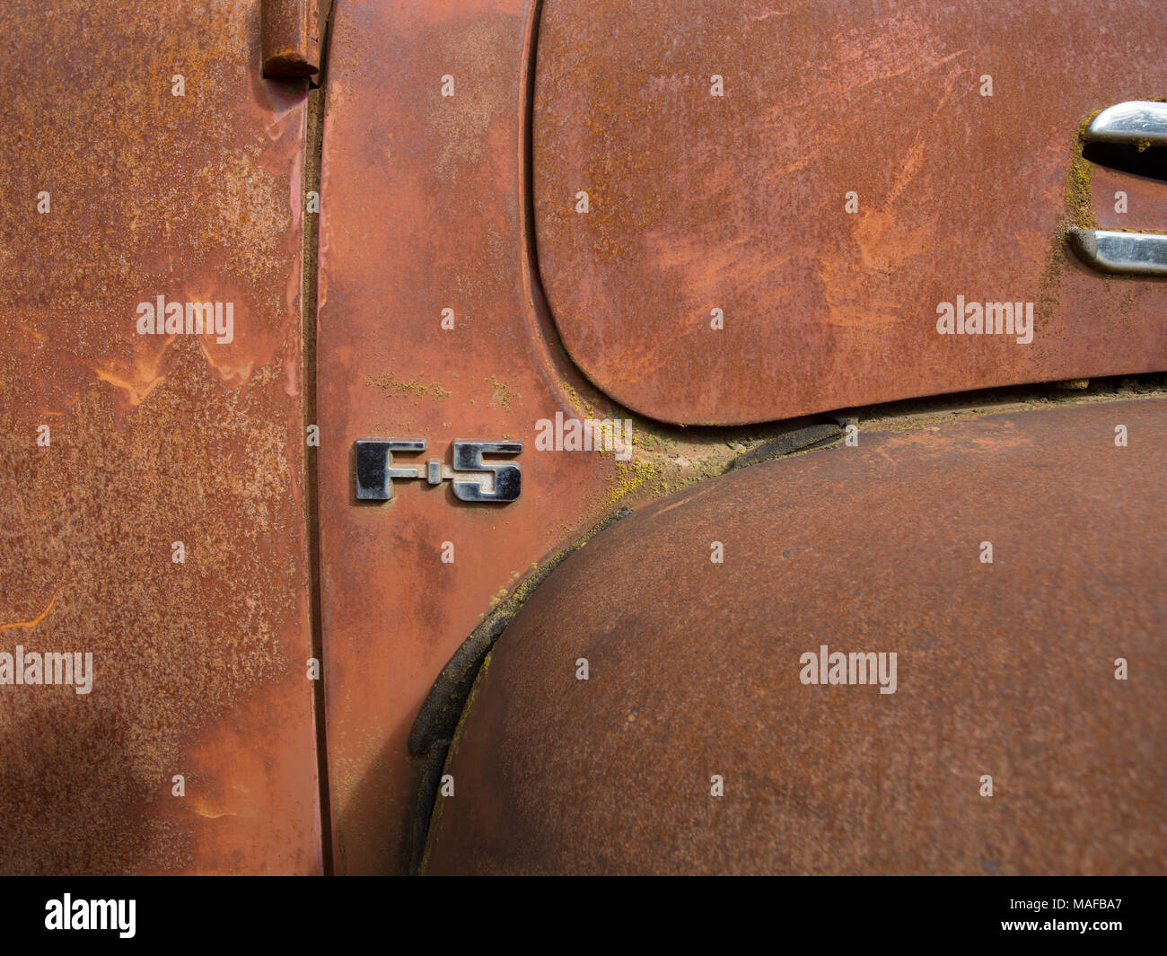 A chromed 'F-5' logo on old 1948 Ford F-5 F5 truck, in a stone quarry, east of Clark Fork Idaho. Stock Photo
