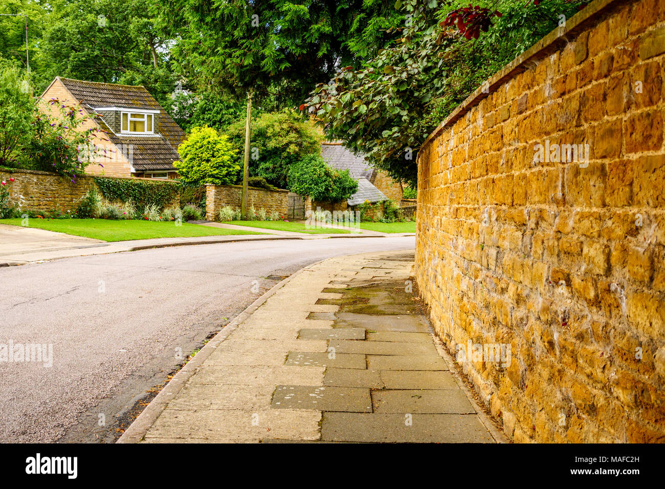 Old English traditional cottage brick wall or fence Stock Photo - Alamy
