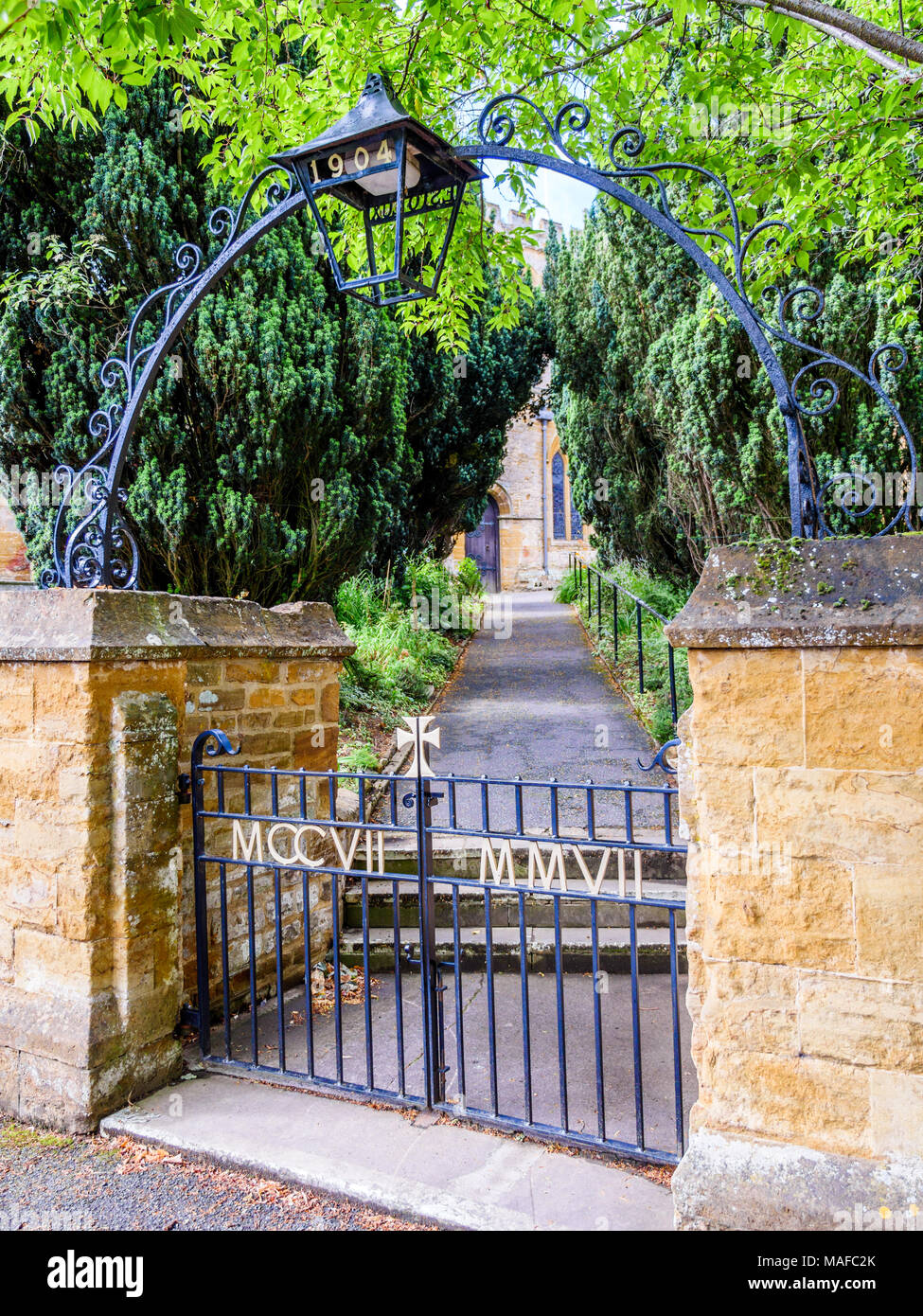 Day view entrance gates to typical Old English Church building. Stock Photo