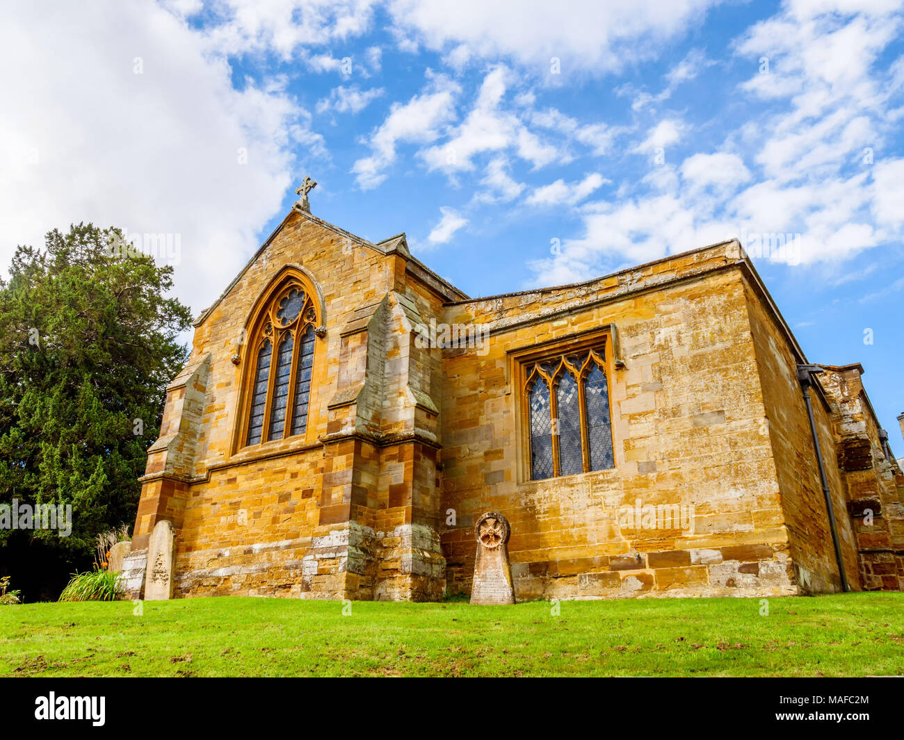 Day view typical Old English Church building over blue sky. Stock Photo