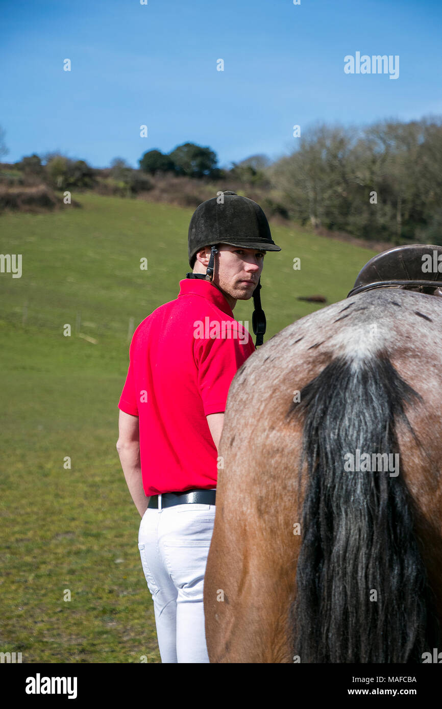 Handsome Male Horse Rider Wearing Helmet Walking Beside Horse