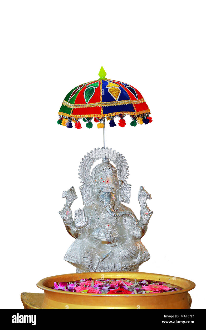 silver statue of hindu god vinayagar and front of water bowl with ...