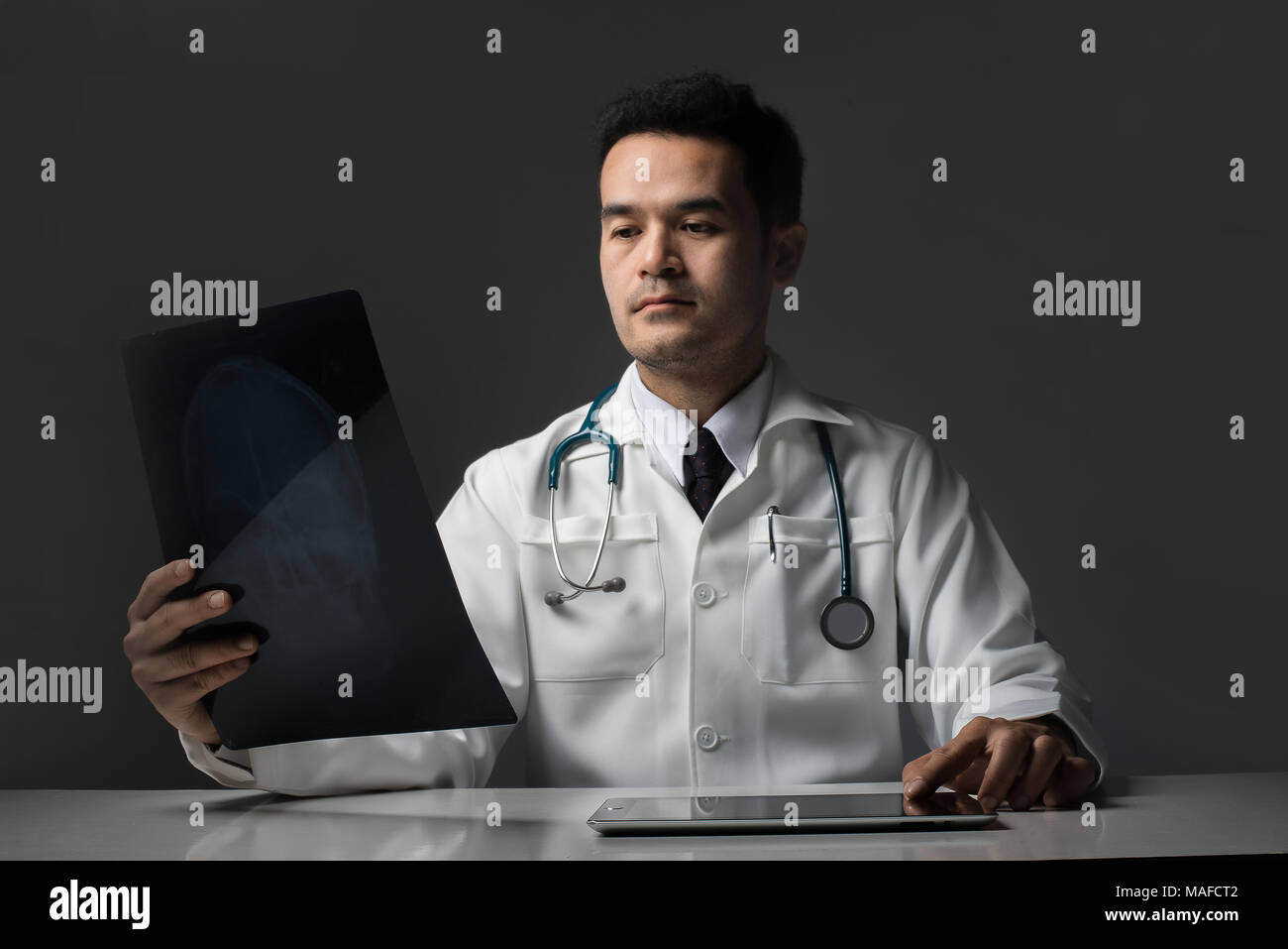 Doctor holding chest x-ray film of patient at hospital Stock Photo - Alamy