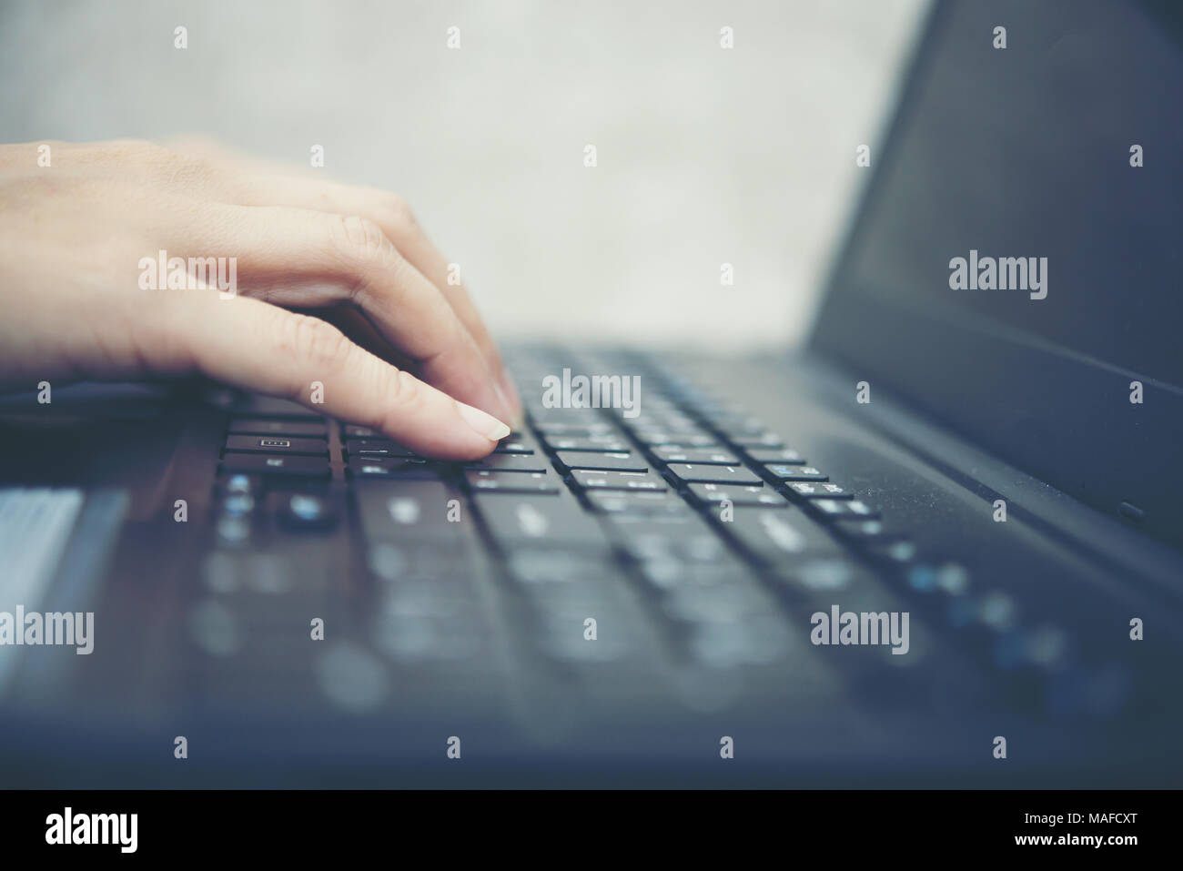 Woman's hand typing with laptop. focus on his finger. Stock Photo