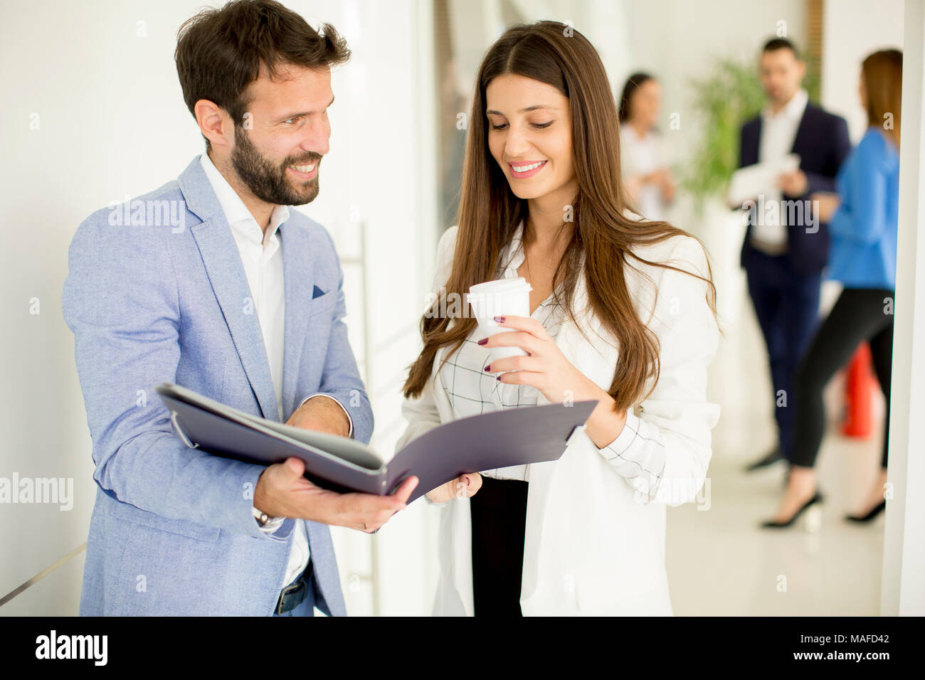 Young couple discussing about business in the modern office Stock Photo