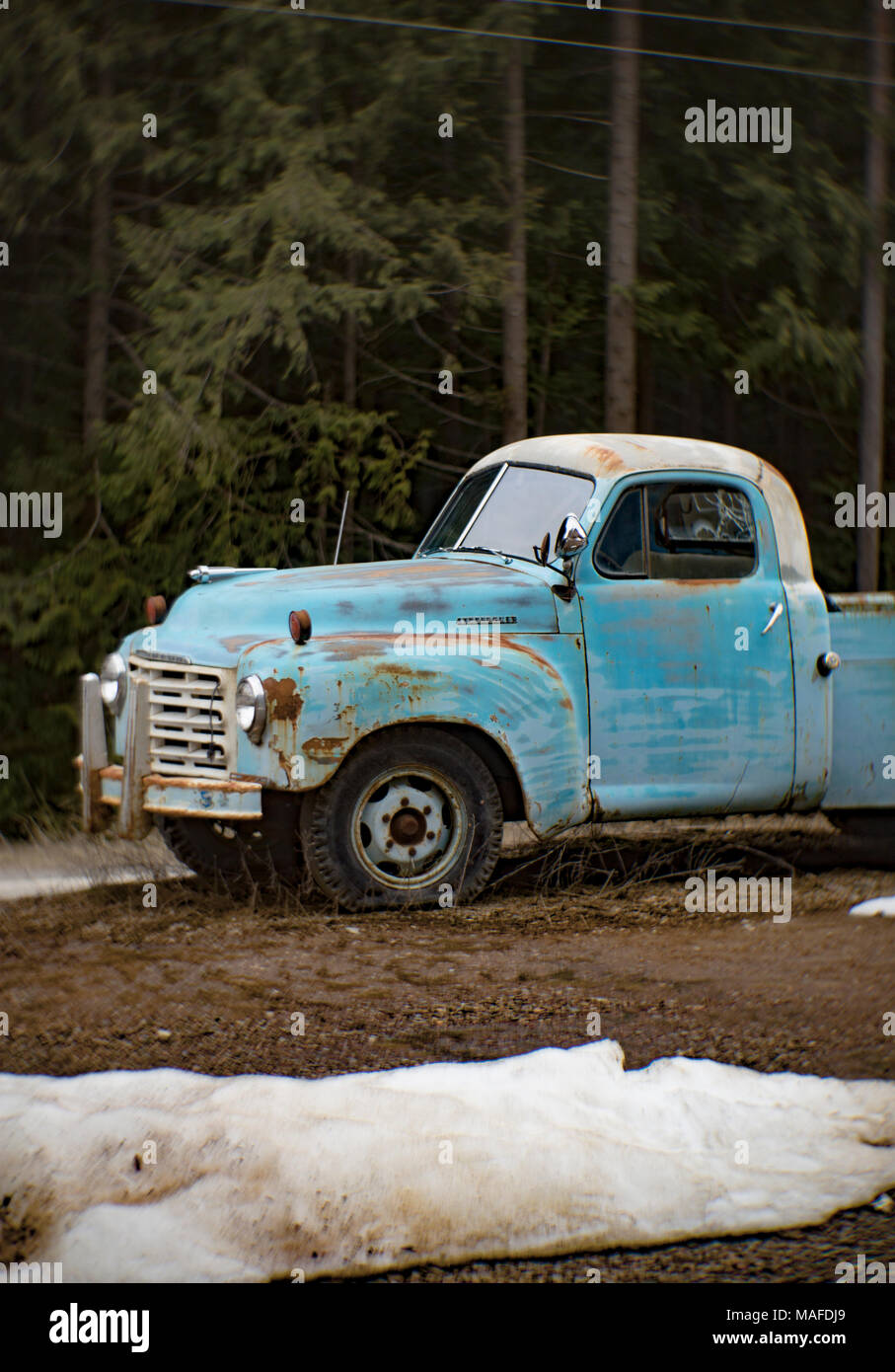 A blue 1957 International S120 pickup truck, in an old quarry, east of Clark Fork Idaho. Stock Photo