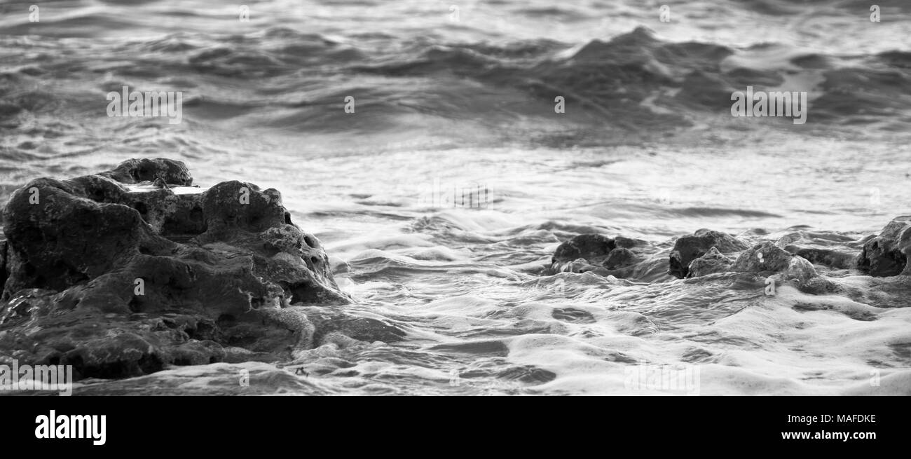 Water waves crashing on rocky Black and White Stock Photos & Images - Alamy
