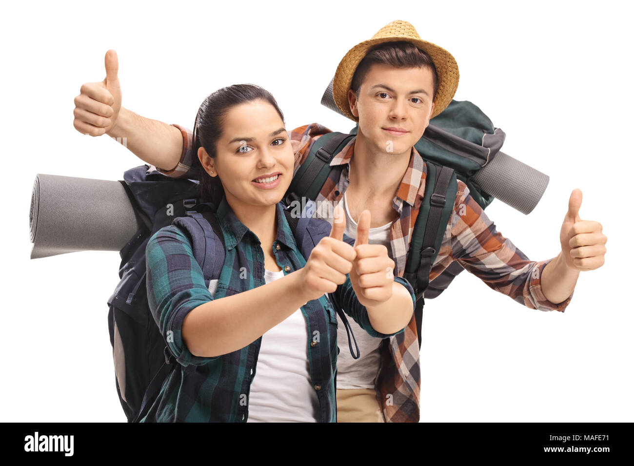 Teenage tourists holding their thumbs up isolated on white background Stock Photo