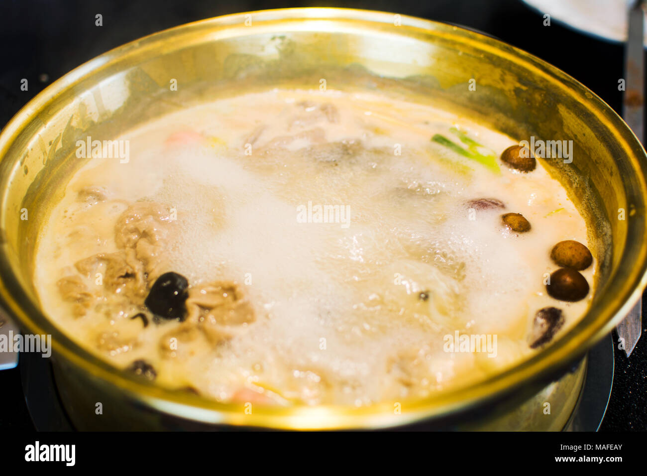 Boiling hotpot close up with many ingredients Stock Photo