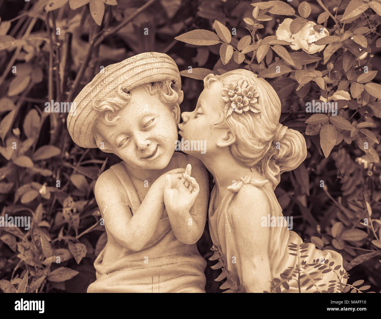 Vintage picture of Boy and girl statues in a park Stock Photo Alamy