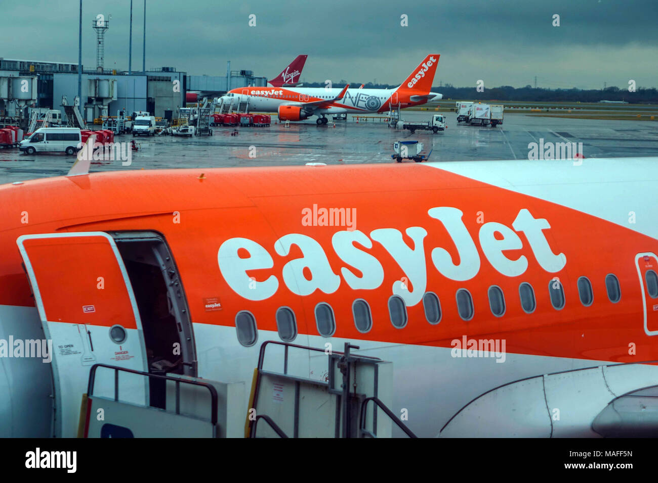 EasyJet Boeing 737 boarding at Manchester airport on rainy day Stock Photo