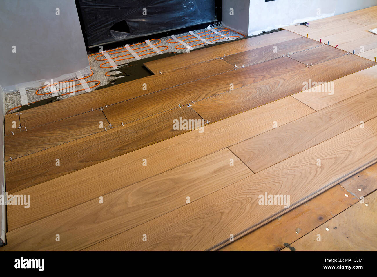 Installation of ceramic tiles and heating elements in warm tile floor