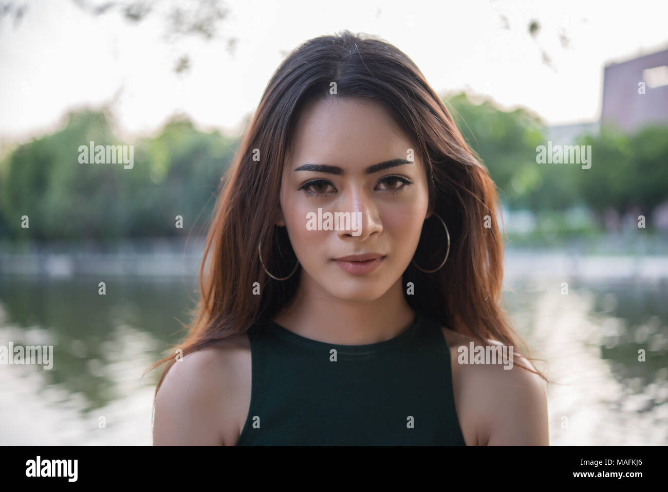 Portrait of a smiling girl relaxing in nature park outdoors Stock Photo ...