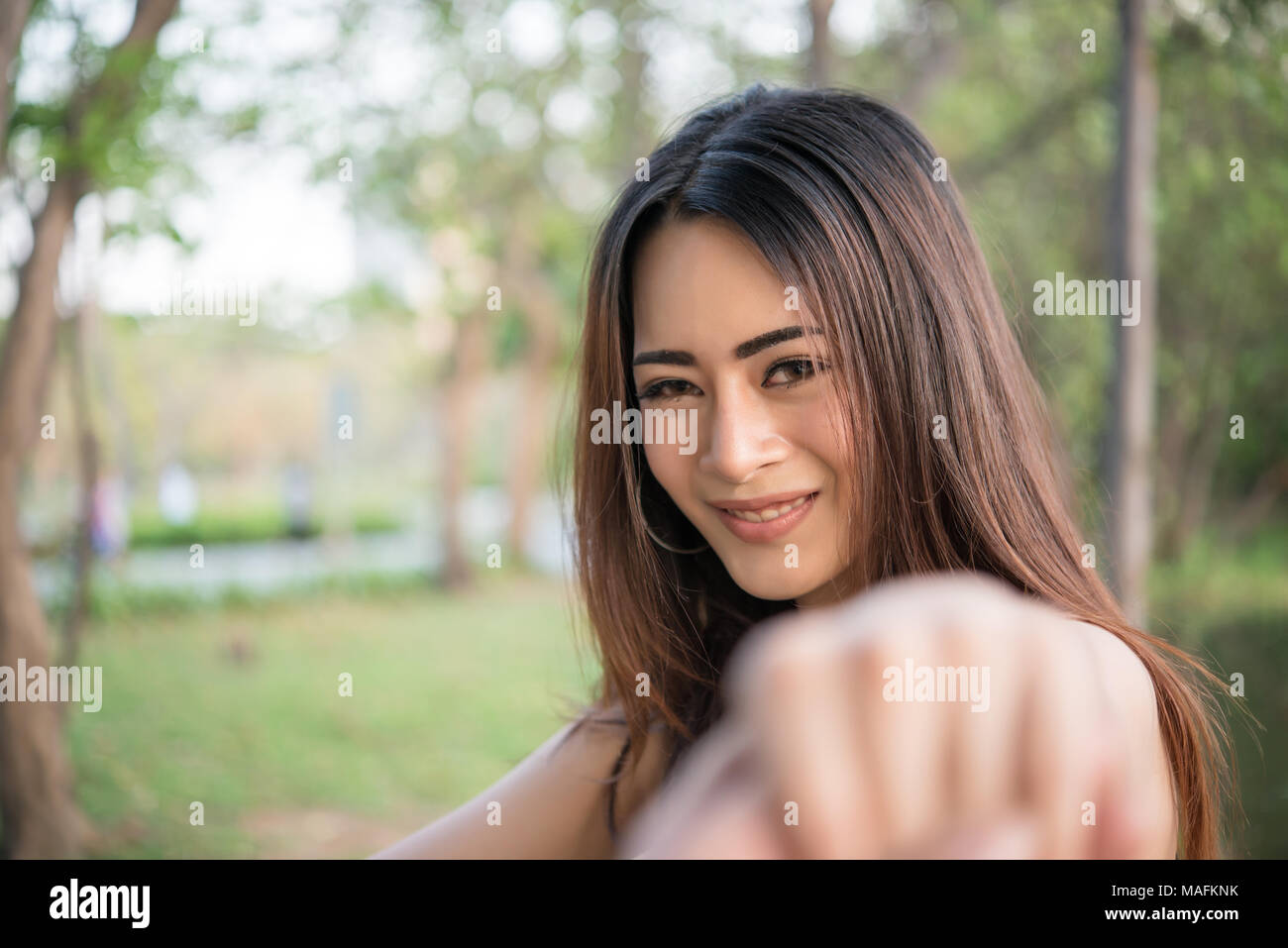 Portrait of a smiling girl relaxing in nature park outdoors Stock Photo ...