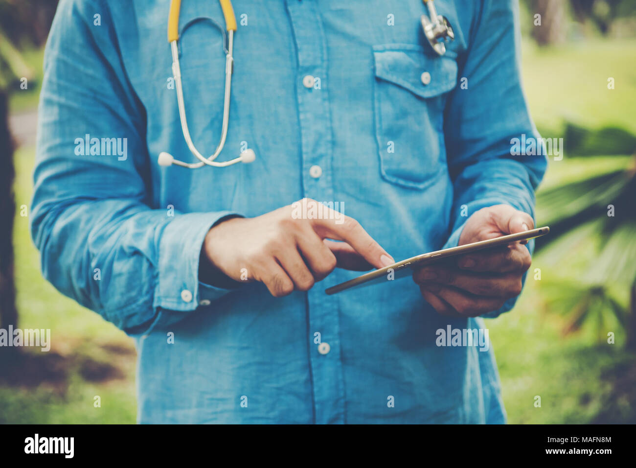 Young student using tablet PC outside on a park . Stock Photo
