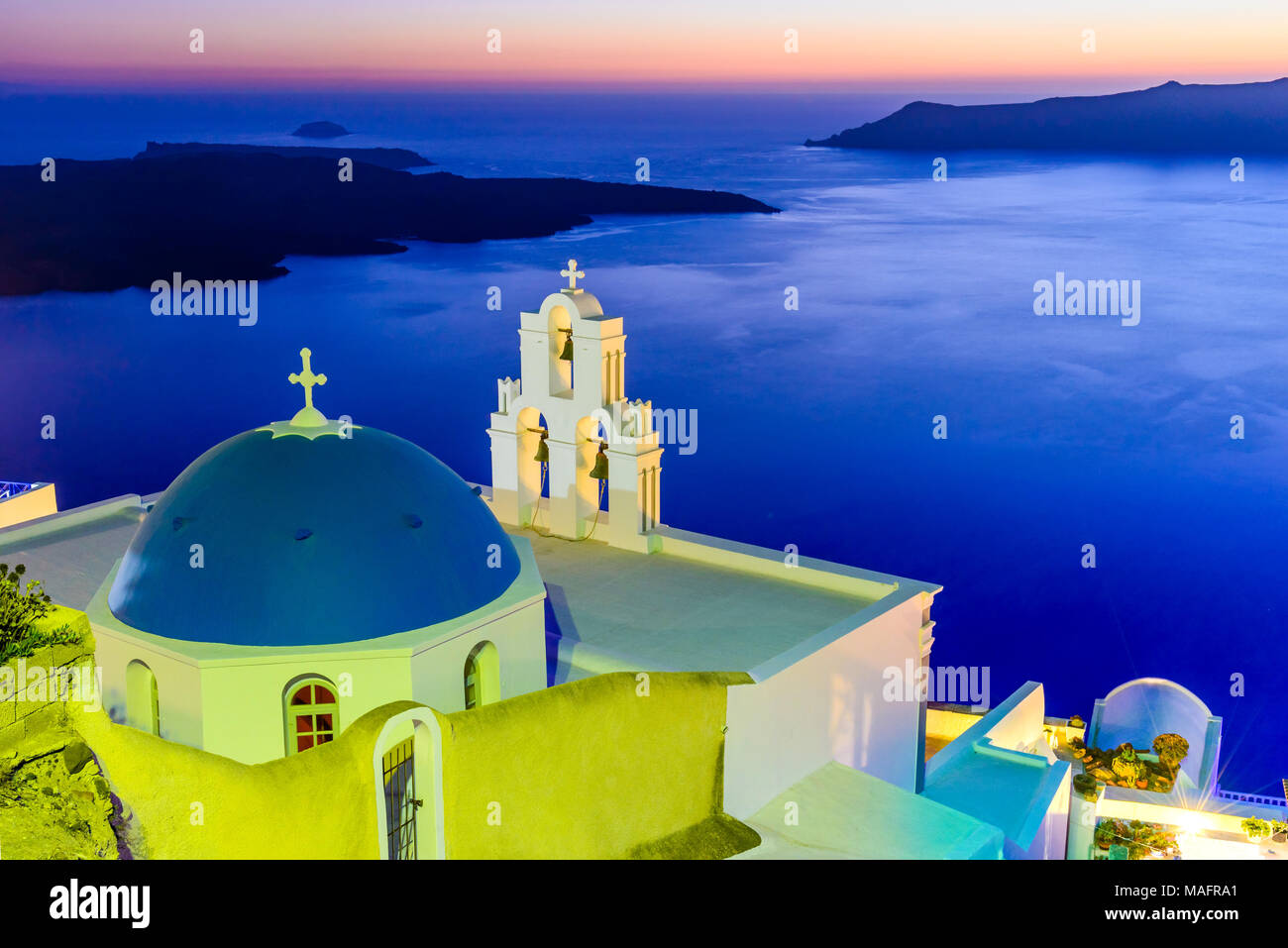 Santorini, Greece. Firostefani twilight with old greek church and caldera at Aegean Sea. Stock Photo