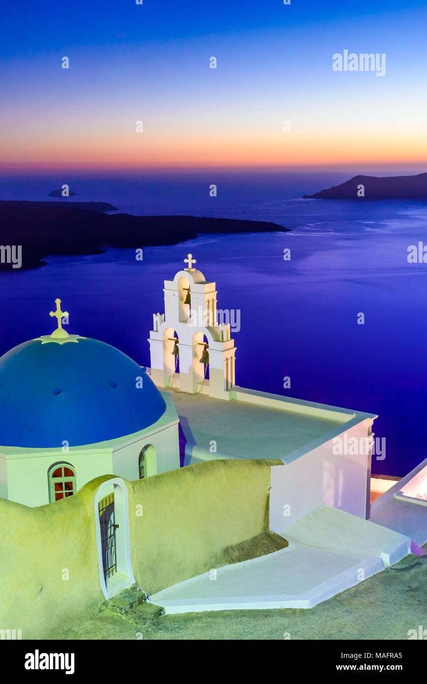Santorini, Greece. Firostefani twilight with old greek church and caldera at Aegean Sea. Stock Photo