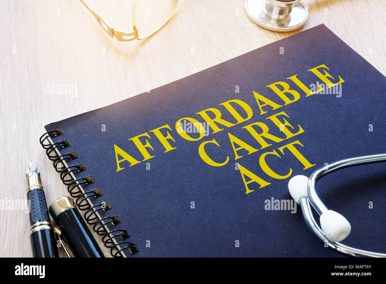 Affordable Care Act ACA and stethoscope on a table. Stock Photo
