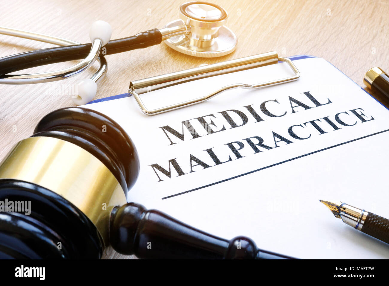 Clipboard with documents about medical malpractice and gavel. Stock Photo