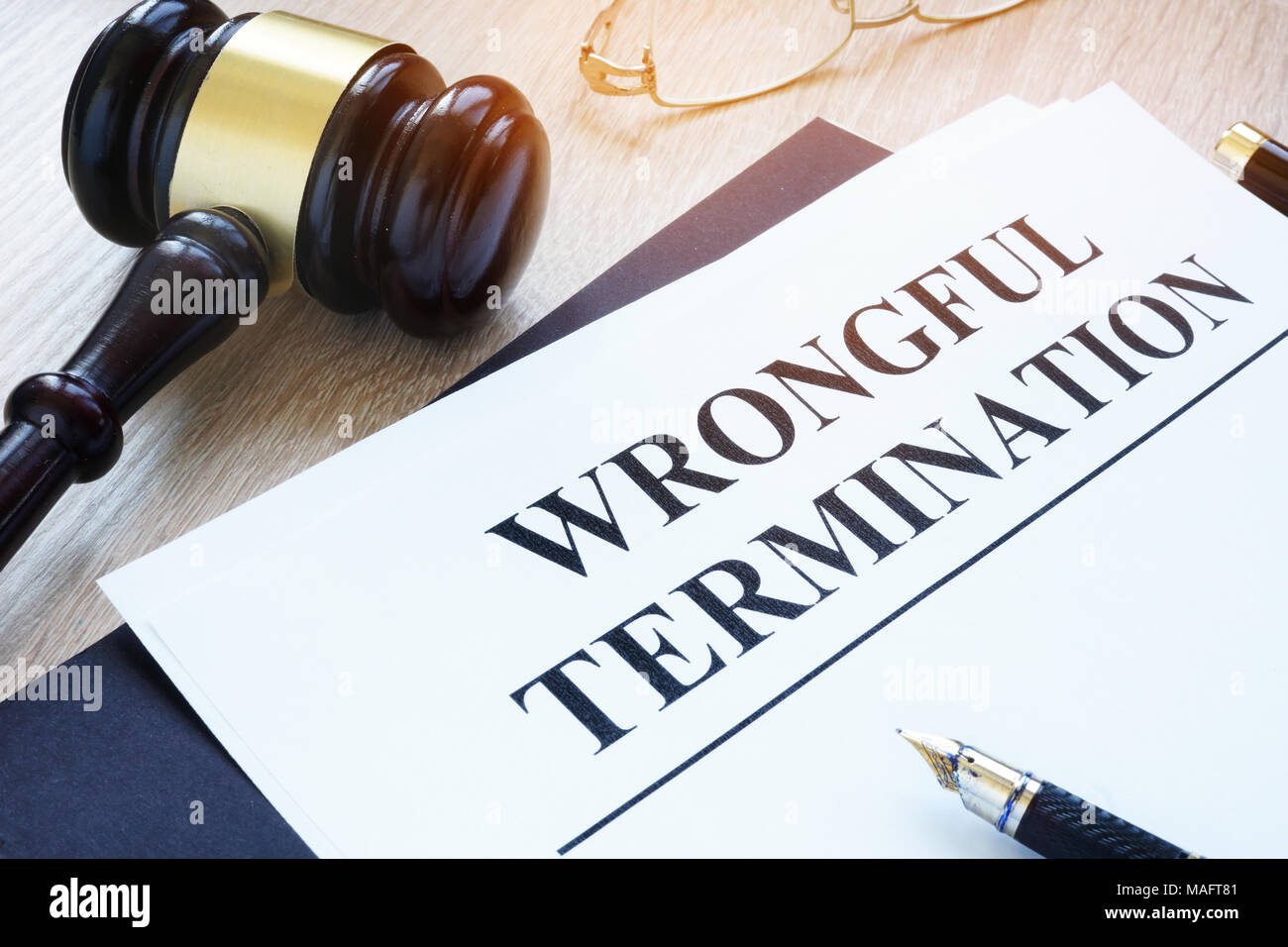 Documents about wrongful termination and gavel. Stock Photo