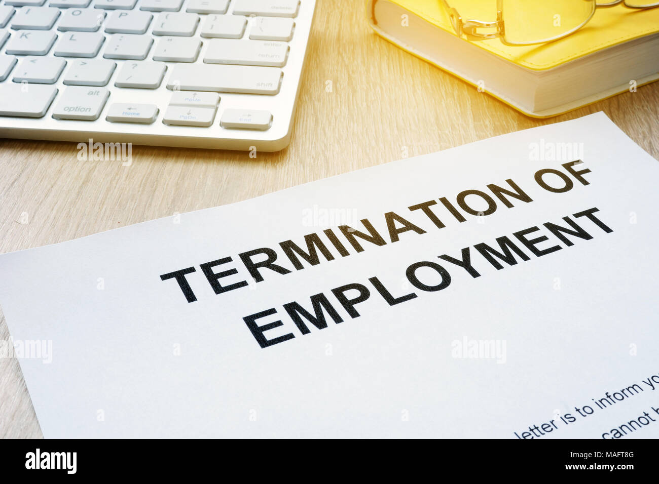 Termination of Employment on an office desk. Stock Photo