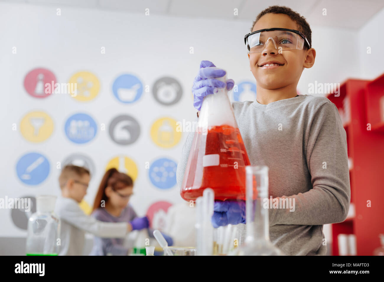 Charming chemistry student posing with a flask Stock Photo