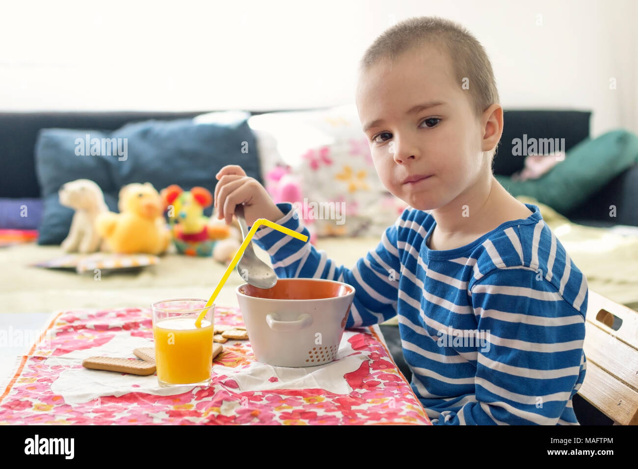 Boy eating milk and cookies for breakfast Stock Photo Alamy