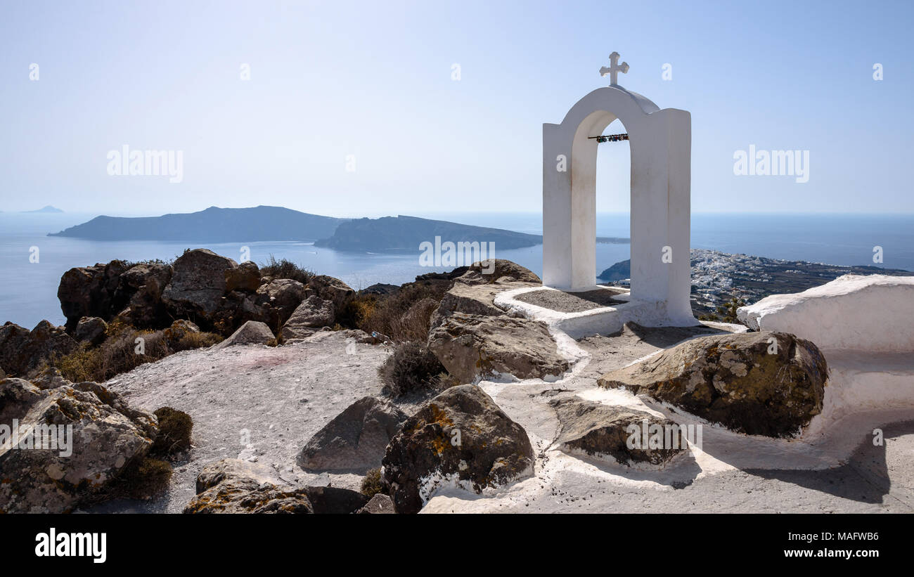 A traditional Greek church arch on Santorini typical of the Cyclades overlooking the Aegean Sea Stock Photo