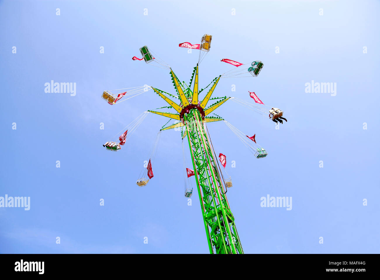 Carousel with people spinning high in the sky. Ride in the Park Stock ...
