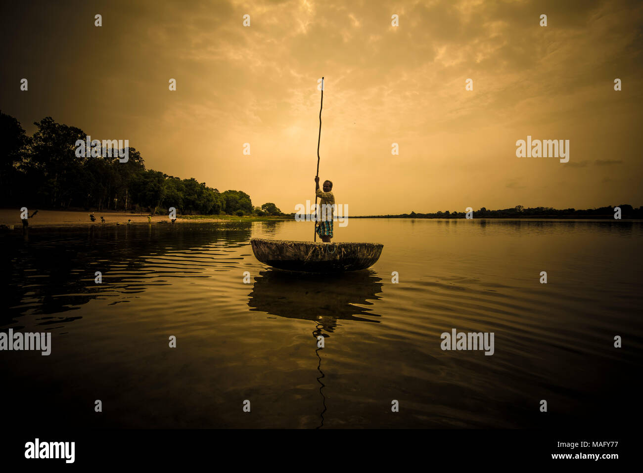 A Happy man on a Round Boat on the Evening Stock Photo