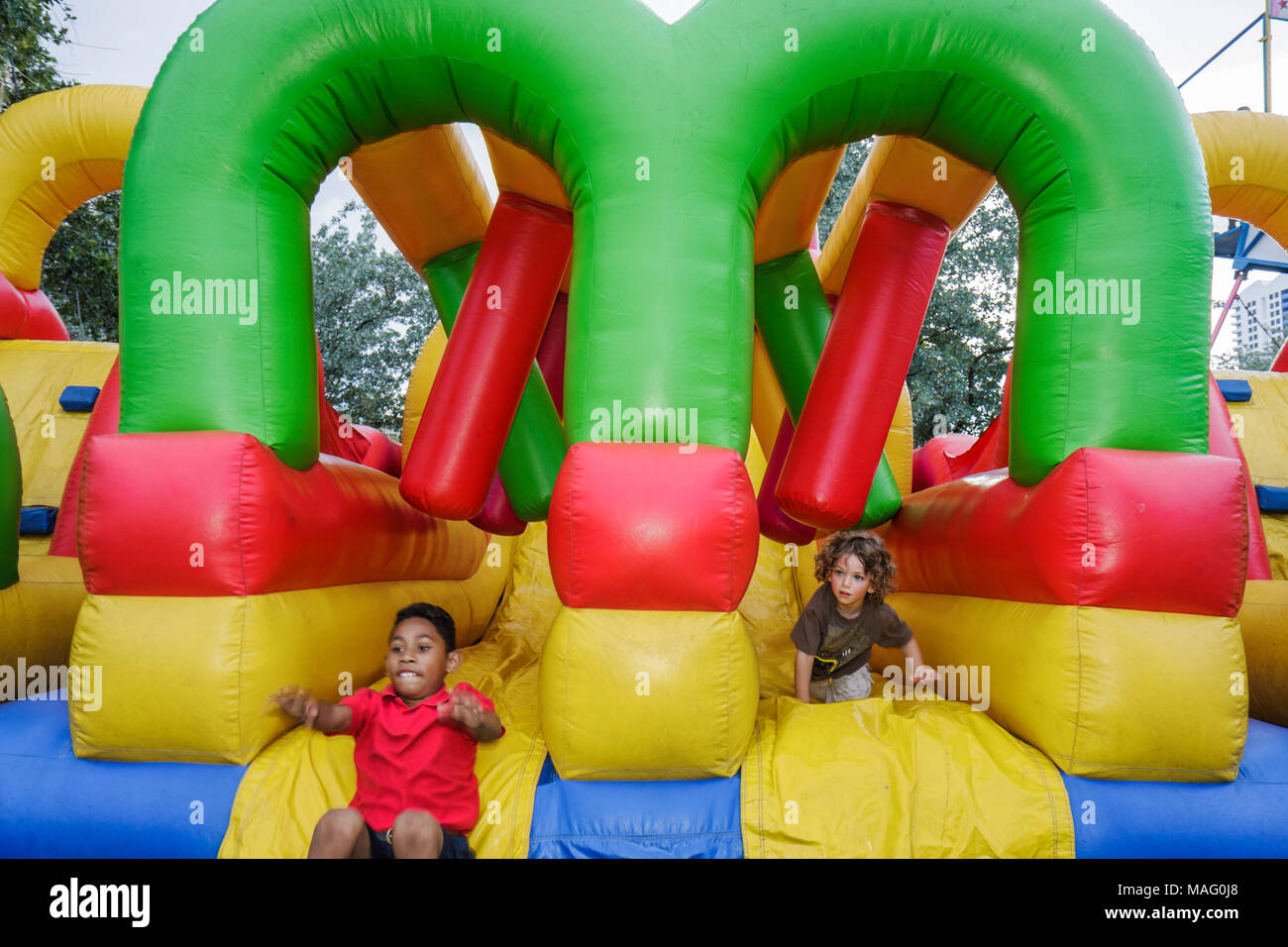 Miami Beach Florida,Flamingo Park,School's Out Fiesta community inflatable obstacle course,amusement,Black male boy boys kids children play,fun,FL0906 Stock Photo