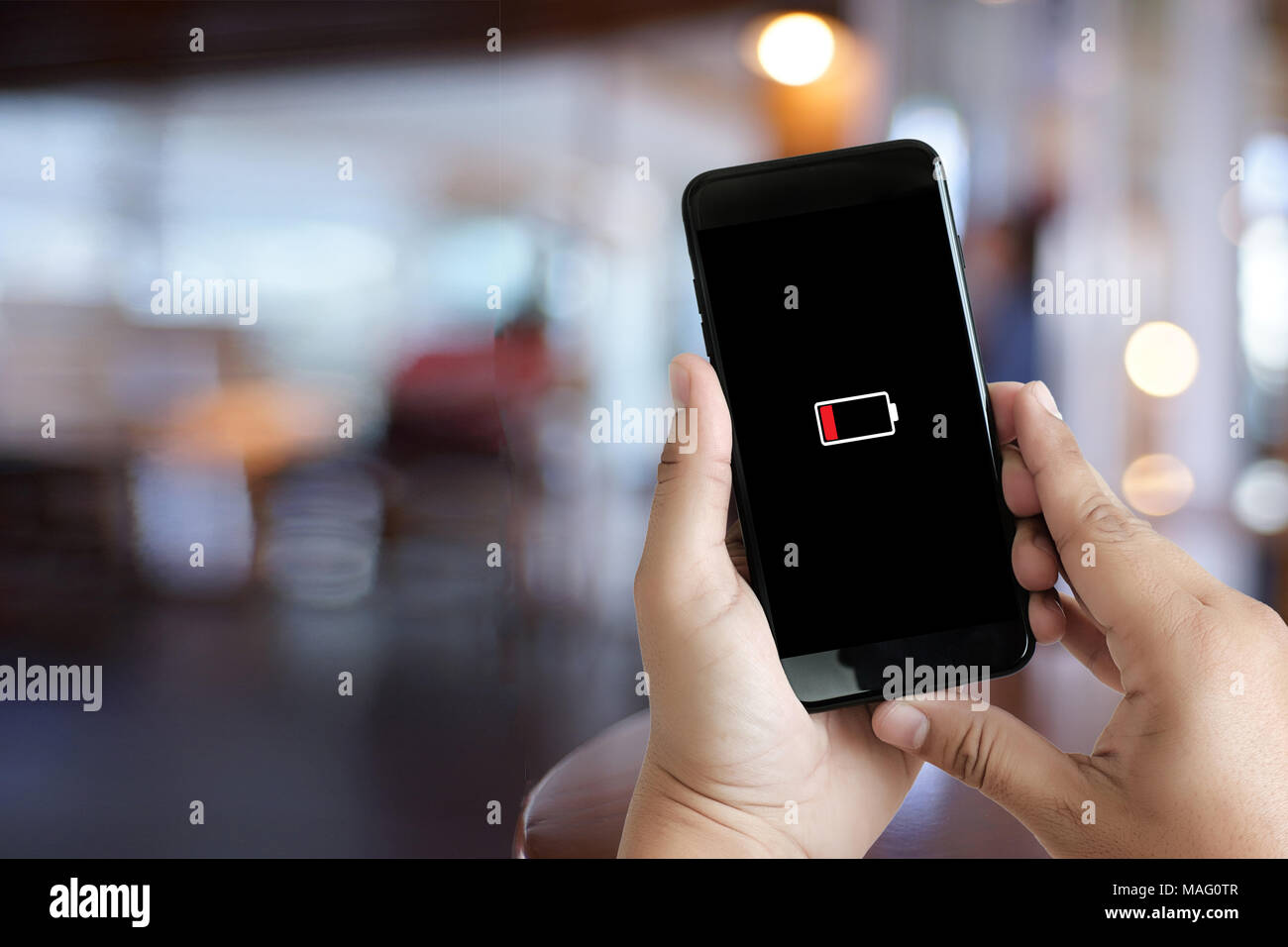 Close up man hands using smart phone battery low charged battery screen Stock Photo
