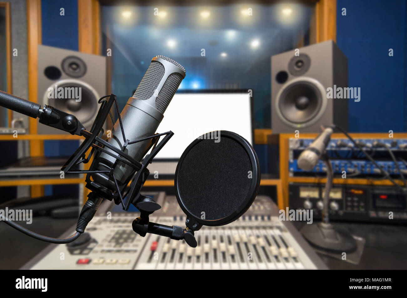 Professional studio microphone over music studio Stock Photo by