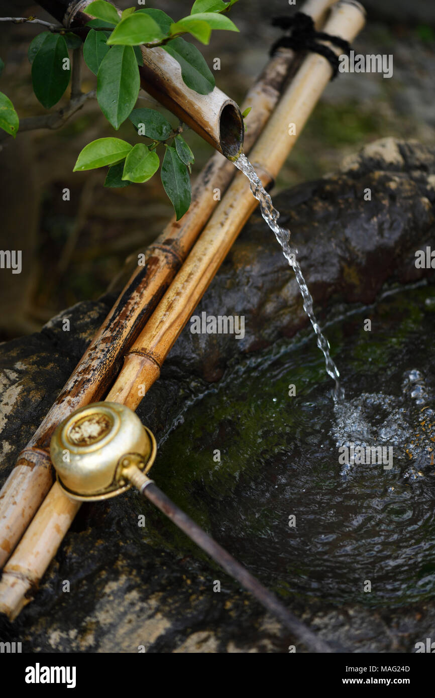 License and prints at MaximImages.com - Chozubachi, water cleansing basin with a bamboo spout and a dipper, showing Japanese Wabi-Sabi philosophy Stock Photo