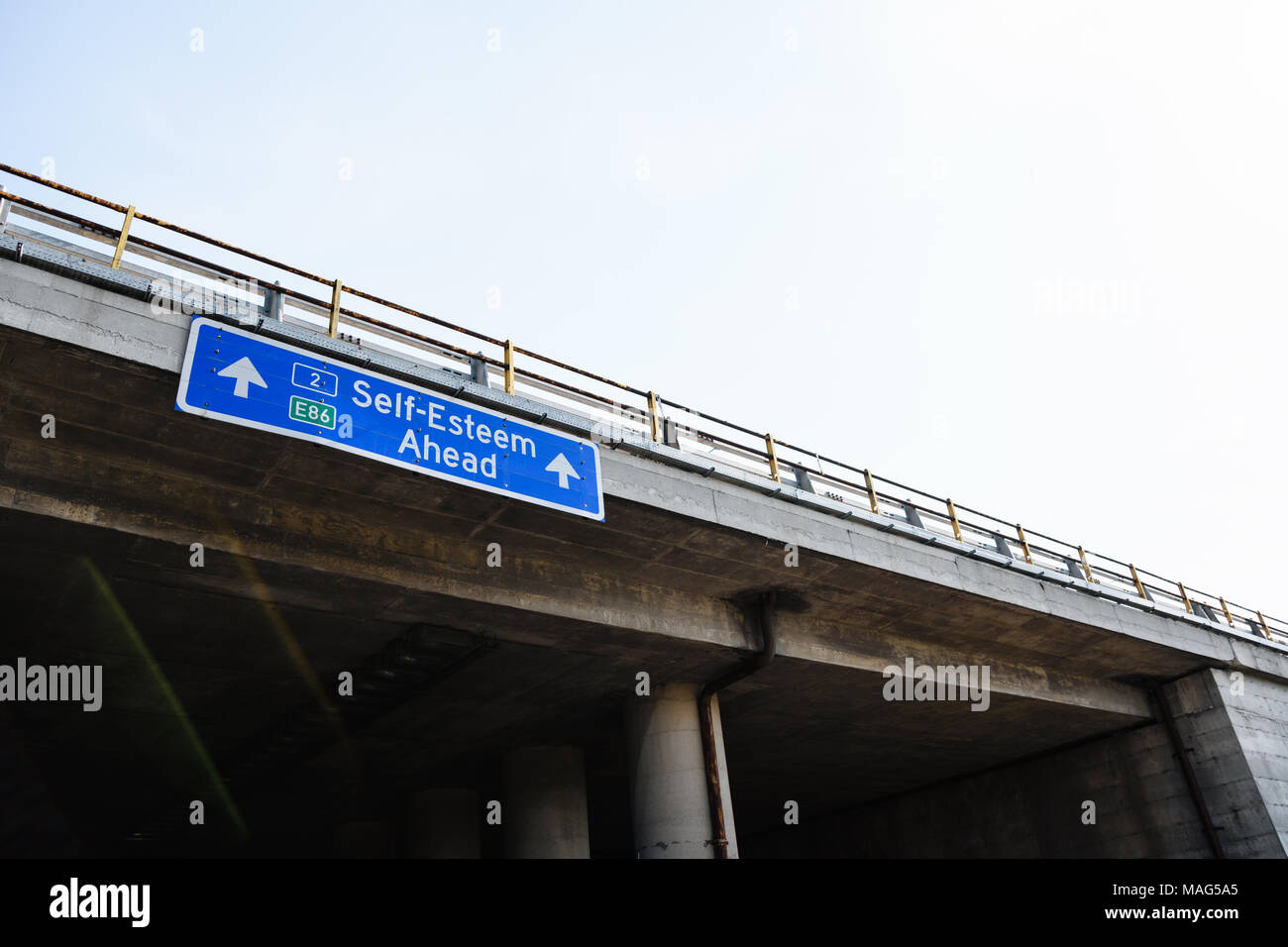 Self-Esteem Ahead Blue Road Sign Against Clear Sky Stock Photo