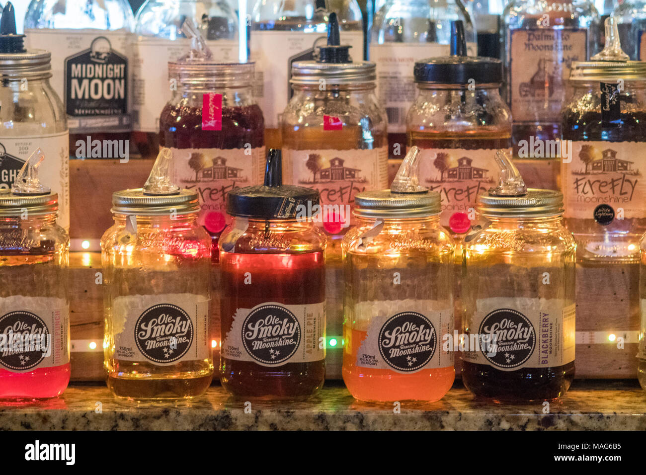 Mason Jars filled with moonshine lined up on a bar wall in Baltimore
