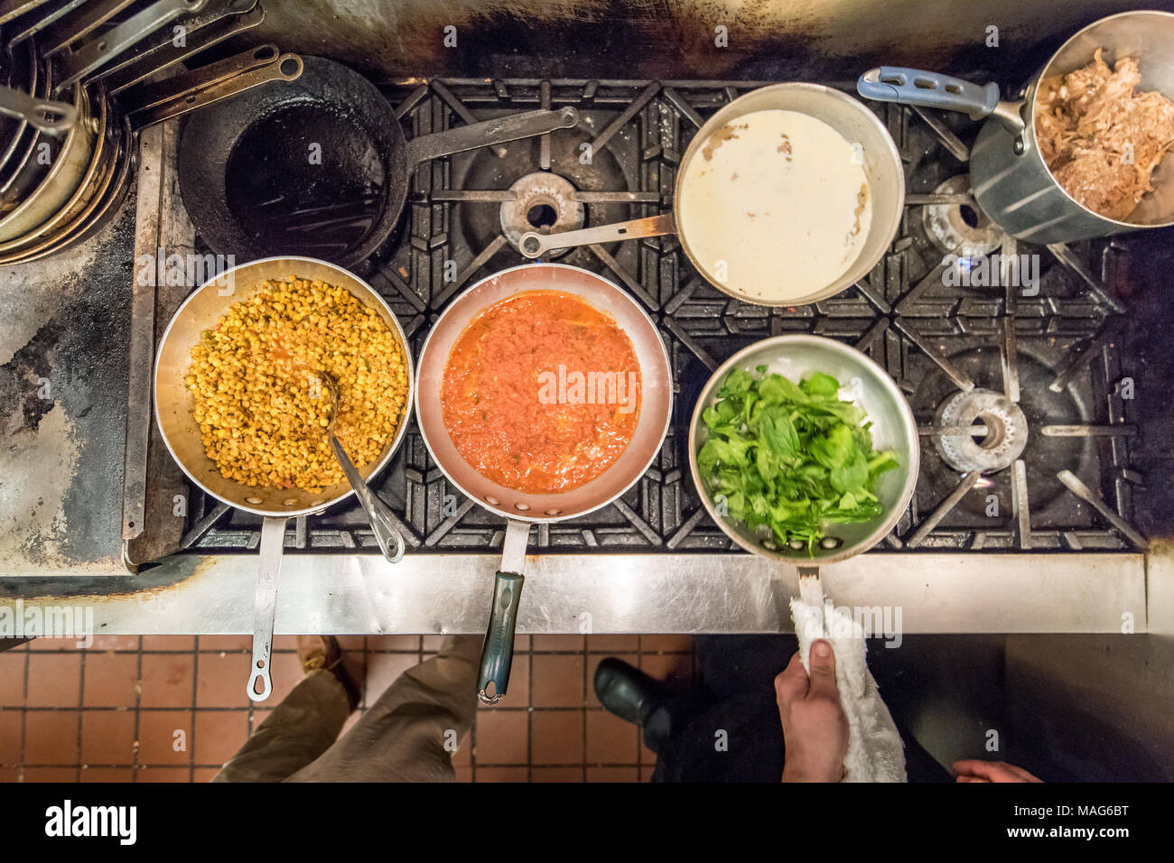 Preparing various dishes in a commercial kitchen in Baltimore, MD Stock