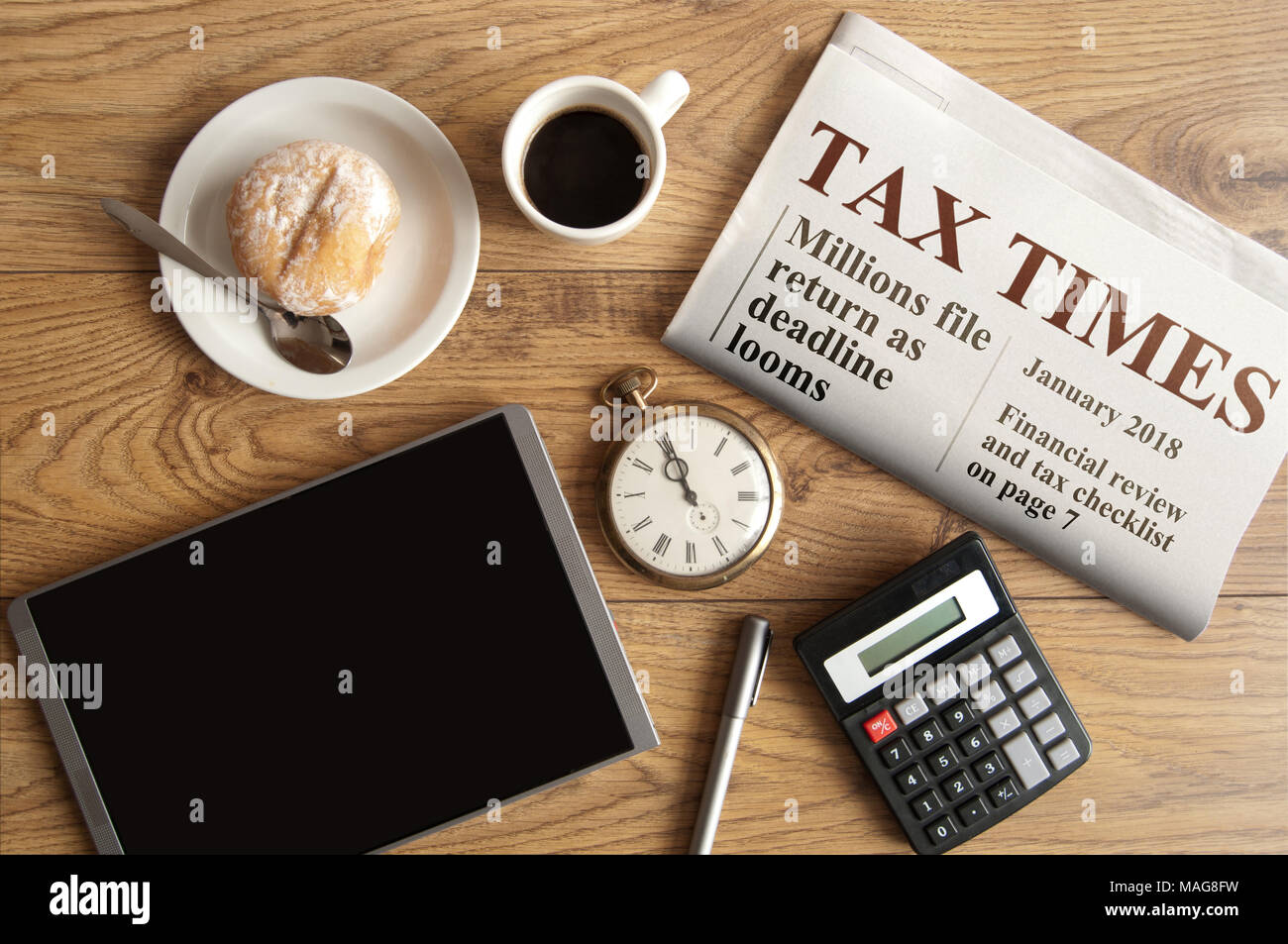 Tax times mock up newspaper with clock, calculator and tablet Stock