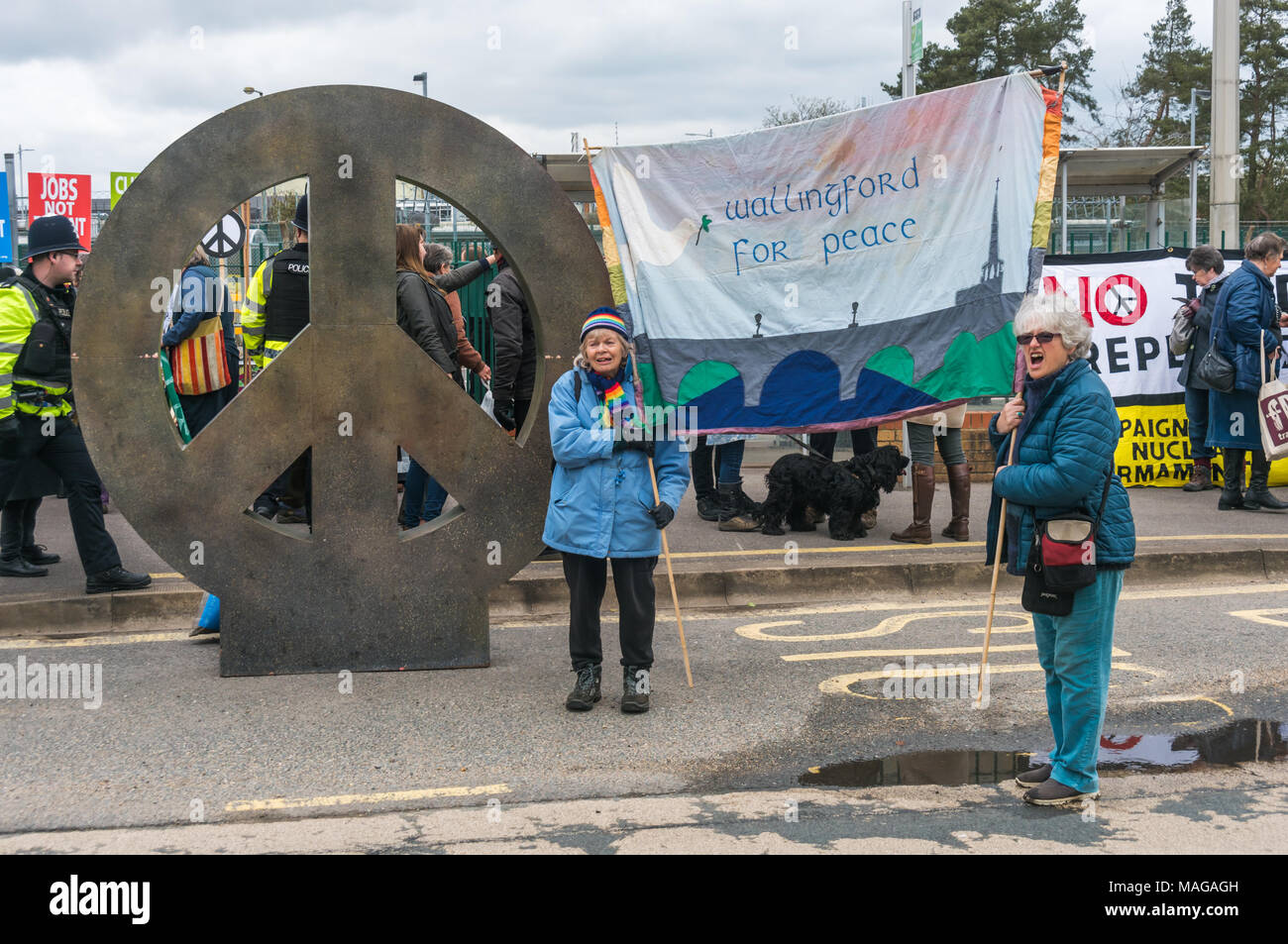 Aldermaston, UK. 1st Apr, 2018. CND erected its giant  CND symbol installation at the main gate of AWE Aldermaston to celebrate the 60th anniversary of the first Aldermaston march which mobilised thousands against the Bomb and shaped radical protest for generations. Their protest outside the Atomic Weapons Establishment included a giant, iconic peace symbol, speeches, including by some of those on the original march, singing and drumming and celebrated the UN treaty banning nuclear weapons. Credit: Peter Marshall/Alamy Live News Stock Photo