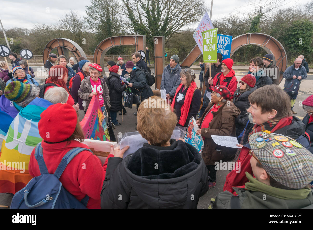 Aldermaston, UK. 1st Apr, 2018. Welsh socialist choir Côr Cochion sings as CND celebrates the 60th anniversary of the first Aldermaston march which mobilised thousands against the Bomb and shaped radical protest for generations. Their protest outside the Atomic Weapons Establishment included a giant, iconic peace symbol, speeches, including by some of those on the original march, singing and drumming and celebrated the UN treaty banning nuclear weapons. Campaign to abolish nuclear weapons. Credit: Peter Marshall/Alamy Live News Stock Photo