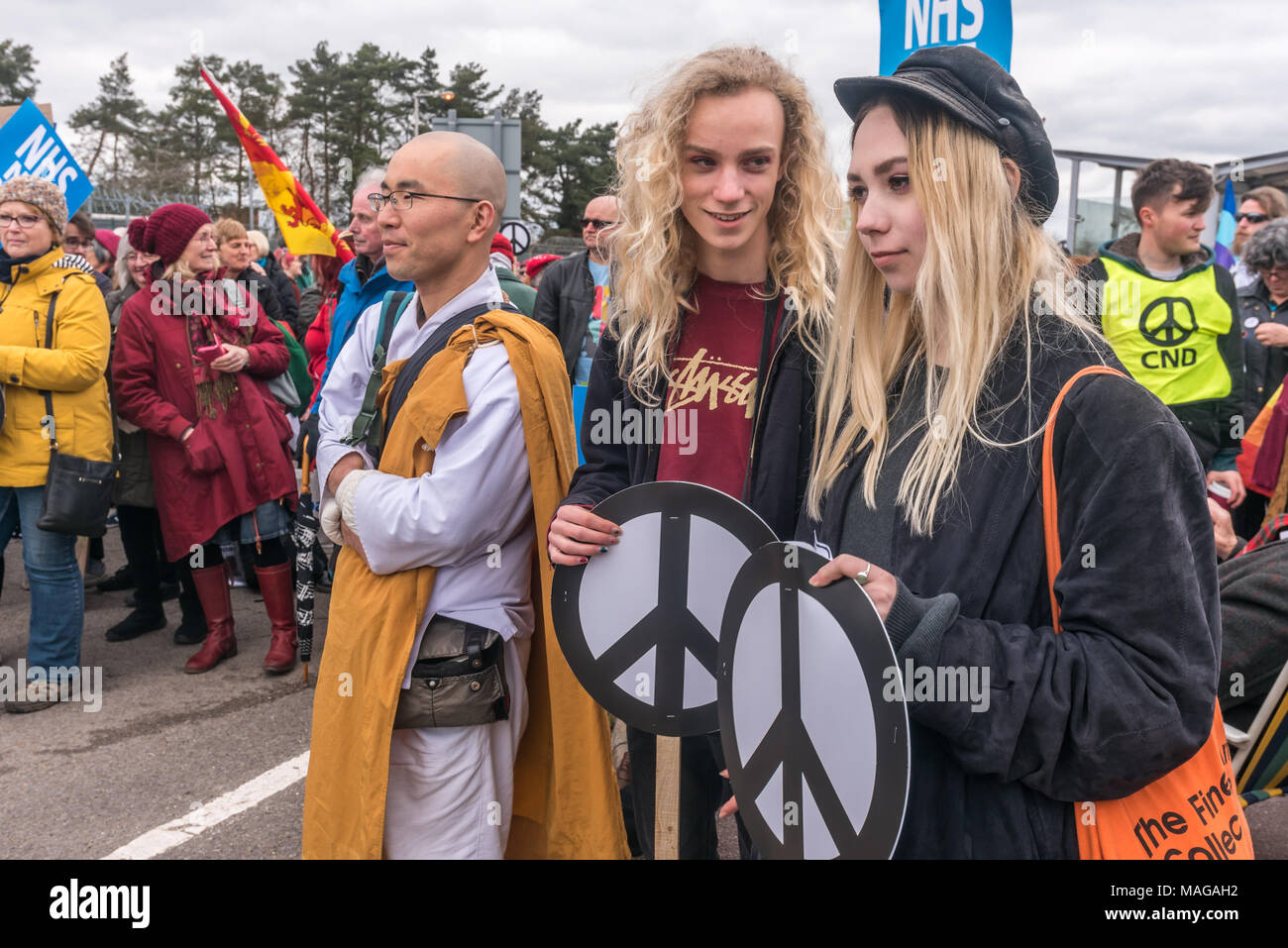 Aldermaston, UK. 1st Apr, 2018. People in the crowd as CND celebrates the 60th anniversary of the first Aldermaston march which mobilised thousands against the Bomb and shaped radical protest for generations. Their protest outside the Atomic Weapons Establishment included a giant, iconic peace symbol, speeches, including by some of those on the original march, singing and drumming and celebrated the UN treaty banning nuclear weapons. Campaign to abolish nuclear weapons. Credit: Peter Marshall/Alamy Live News Stock Photo