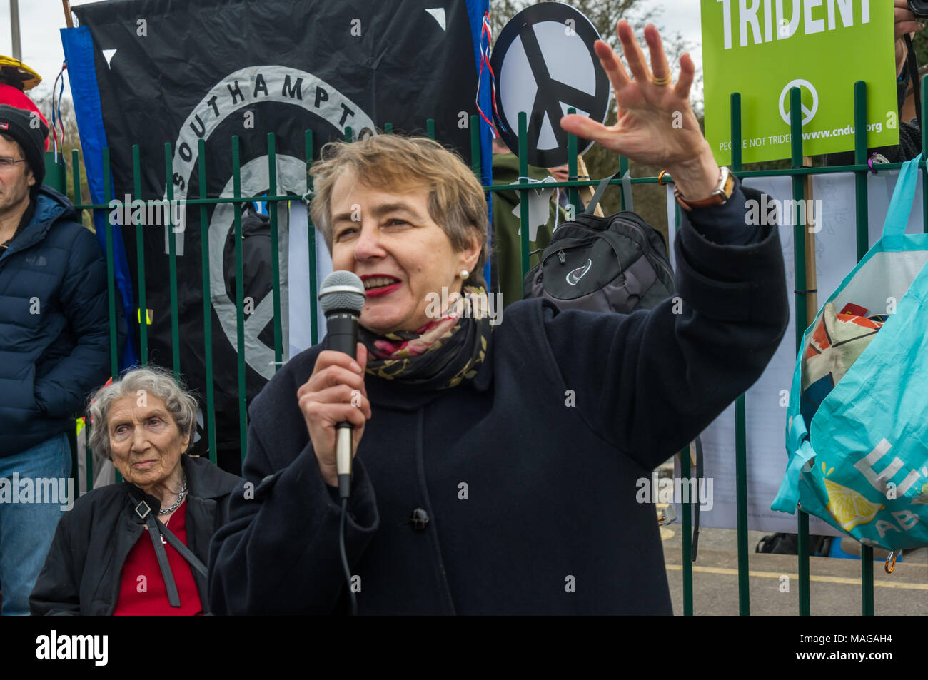 Aldermaston, UK. 1st Apr, 2018. Kate Hudson speaks as CND celebrates the 60th anniversary of the first Aldermaston march which mobilised thousands against the Bomb and shaped radical protest for generations. Their protest outside the Atomic Weapons Establishment included a giant, iconic peace symbol, speeches, including by some of those on the original march, singing and drumming and celebrated the UN treaty banning nuclear weapons. Campaign to abolish nuclear weapons. Credit: Peter Marshall/Alamy Live News Stock Photo
