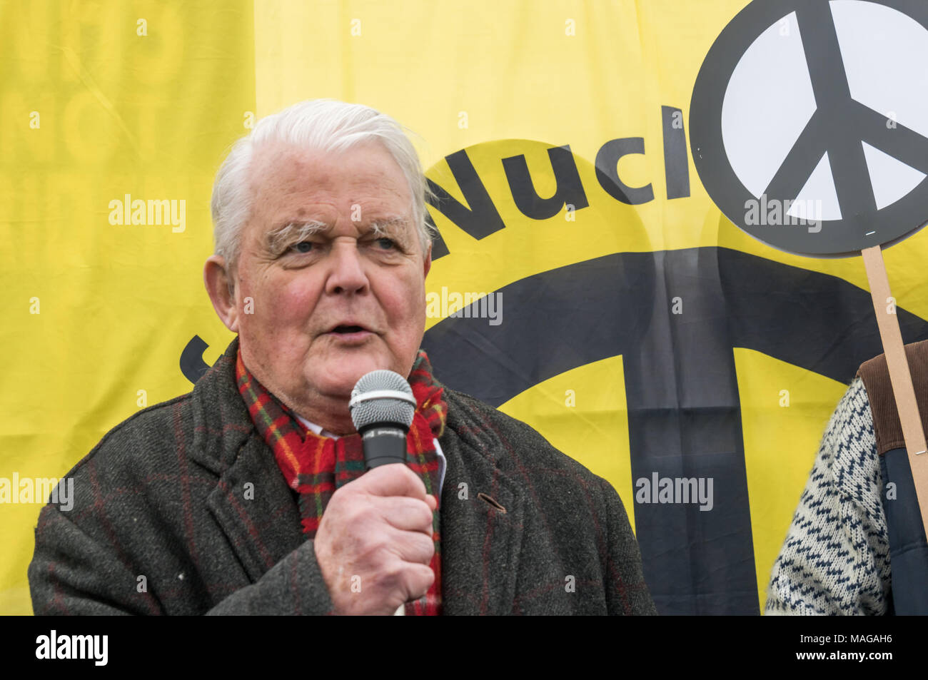 Aldermaston, UK. 1st Apr, 2018. Veteran peace campaigner and CND Vice-President Bruce Kent speaks at the CND celebration of the 60th anniversary of the first Aldermaston march which mobilised thousands against the Bomb and shaped radical protest for generations. Their protest outside the Atomic Weapons Establishment included a giant, iconic peace symbol, speeches, including by some of those on the original march, singing and drumming and celebrated the UN treaty banning nuclear weapons. Credit: Peter Marshall/Alamy Live News Stock Photo