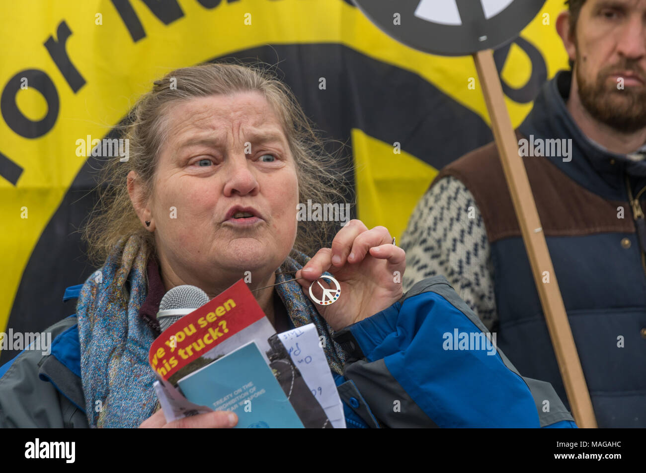 Aldermaston, UK. 1st Apr, 2018. Dr Rebecca Johnson, co-Chair of ICAN, long-time feminist peace campaigner and 2017 Nobel Laureate, holds a CND symbol and a copy of the UN treaty banning nuclear weapons. which was finalised last year and signed by 122 nations as she speaks at the CND celebration of the 60th anniversary of the first Aldermaston march which mobilised thousands against the Bomb and shaped radical protest for generations. Credit: Peter Marshall/Alamy Live News Stock Photo