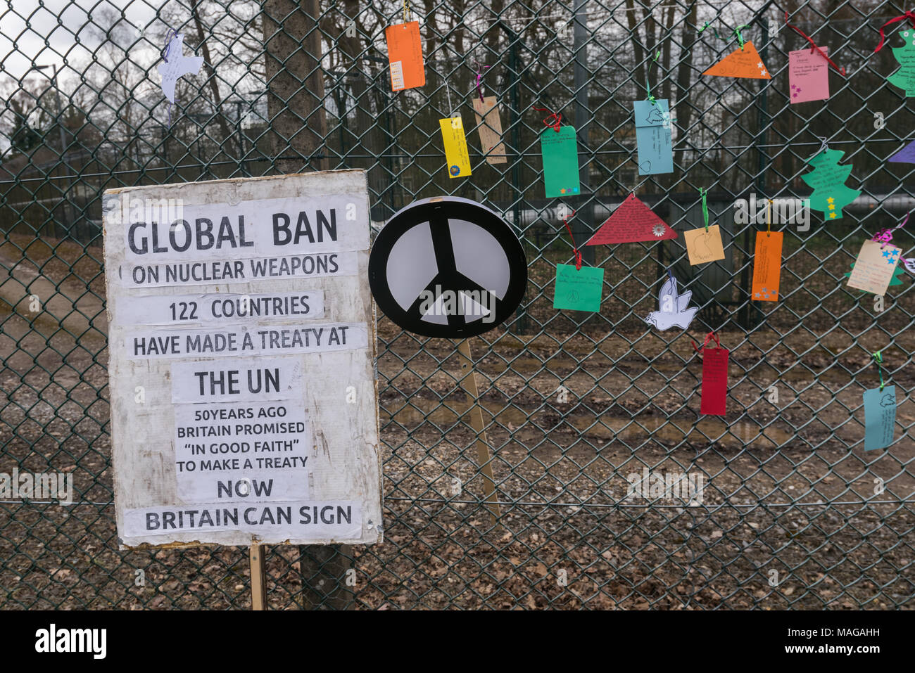 Aldermaston, UK. 1st Apr, 2018. A poster about the UN Global treaty signed by 122 countries points out that 50 years ago Britain promised 'in good faith' it would take part in such a treaty if it existed. Now there is a UN treaty Britain is now refusing to sign. Placards and peace messages were tied on the security fence of AWR Aldermaston as CND celebrated the 60th anniversary of the first Aldermaston march which mobilised thousands against the Bomb and shaped radical protest for generations. Credit: Peter Marshall/Alamy Live News Stock Photo