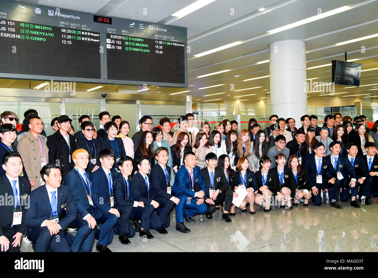 South Korean art troupe and taekwondo athletes in Pyongyang, Mar 31, 2018 : South Korean art troupe and taekwondo athletes pose for photos upon their arrival at Sunan airport in Pyongyang, North Korea. South Korean taekwondo athletes and K-Pop musicians such as Cho Yong-pil, Lee Sun-hee, Choi Jin-hee, Yoon Do-hyun (YB), Baek Ji-young, Red Velvet, Jungin, Seohyun (Girls' Generation), Ali, Kang San-eh and Kim Kwang-min will perform at the East Pyongyang Grand Theater on Sunday and will perform in a joint concert with North Korean artists on Tuesday at the Ryugyong Jong Ju Yong Gymnasium in Pyong Stock Photo